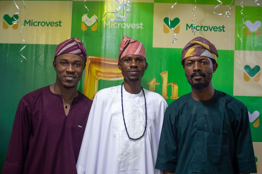 Three colleagues in matching caps at the anniversary celebration